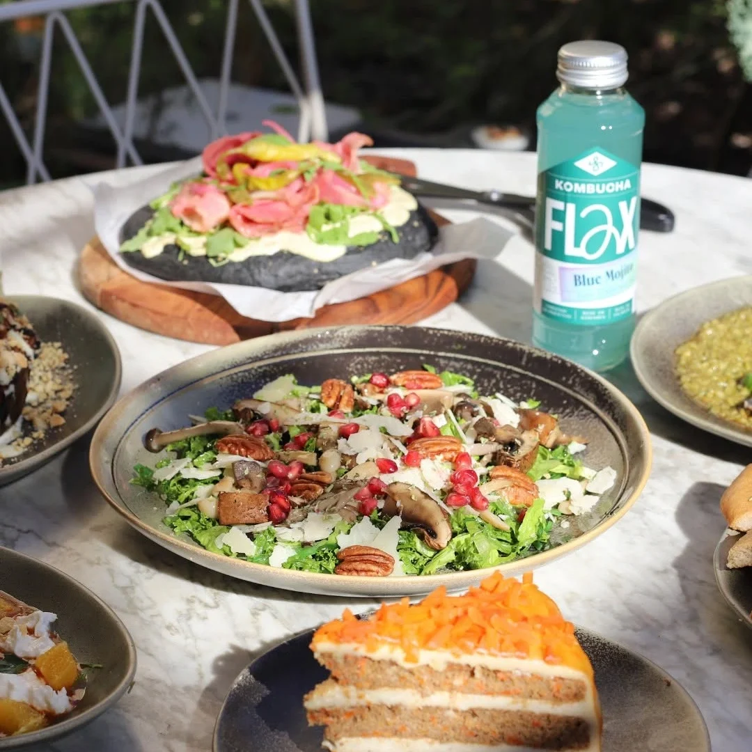 A vibrant selection of healthy salads with fresh greens, nuts, roasted vegetables, and creamy dressings, presented on stylish ceramic plates