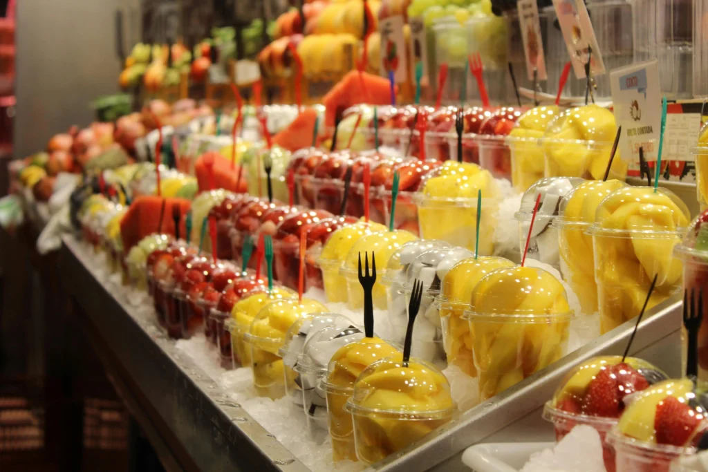 Fresh fruit cups with mango, watermelon, and strawberries at a Barcelona market