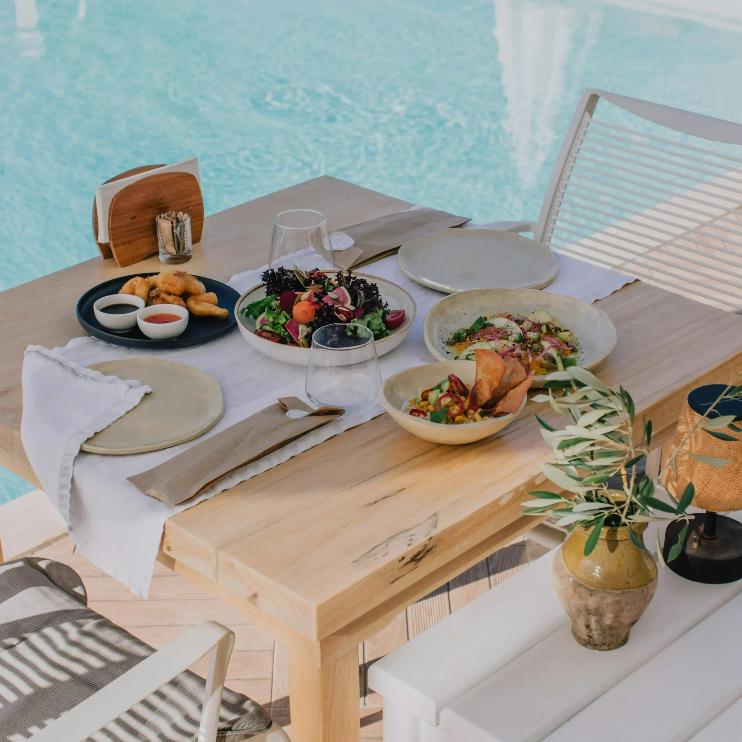A rooftop bar with a table with a tapas spread across it