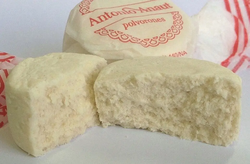 Traditional handmade polvorón wrapped in paper, typical of Christmas, with a soft texture and homemade look—ideal as a festive sweet gift.