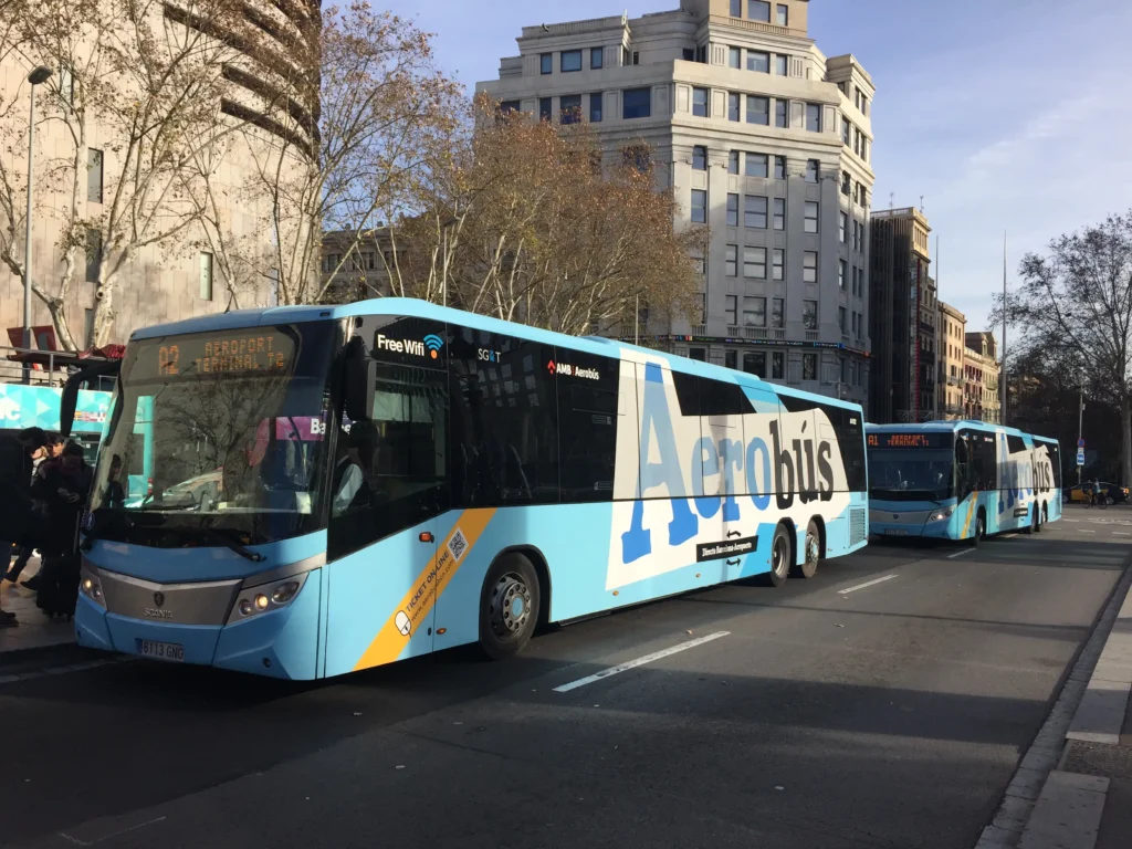 Aerobus buses parked on a main avenue in central Barcelona, offering a direct connection between the city and the airport.