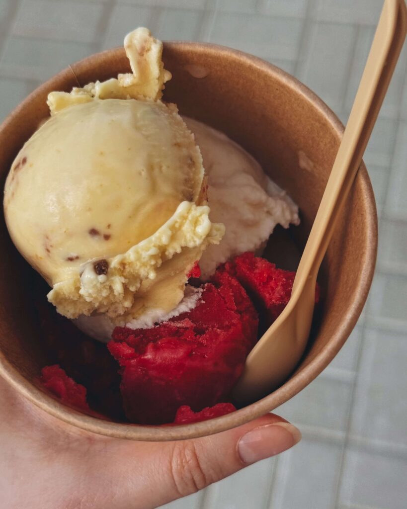 Two scoops of ice cream in a tub.