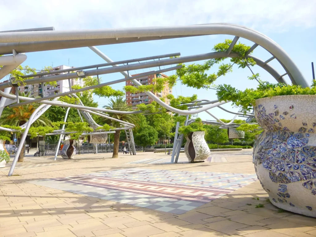 The iconic metal structures and mosaic planters at Parc de Diagonal Mar in Barcelona, combining contemporary design, public art and green spaces.
