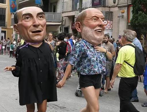 Traditional Catalan capgrossos parading through the streets of Barcelona during a local festival.