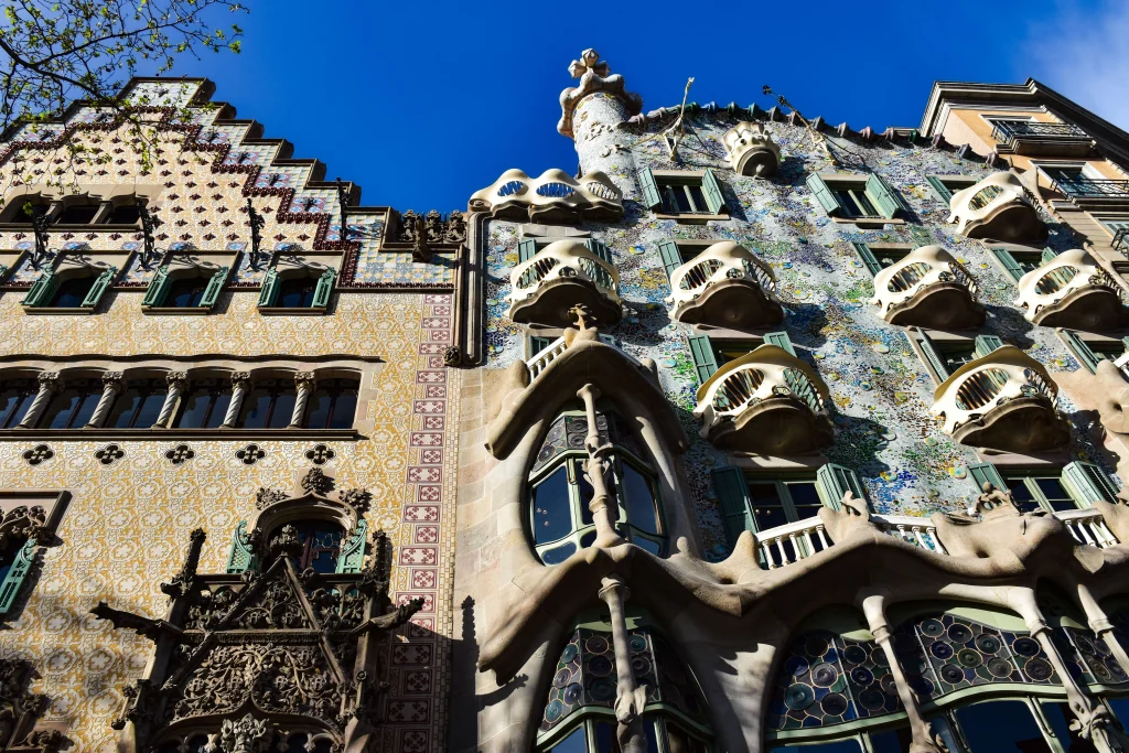 Façade of Casa Batlló in Barcelona with its colourful mosaics, curved balconies and distinctive Modernist architecture.
