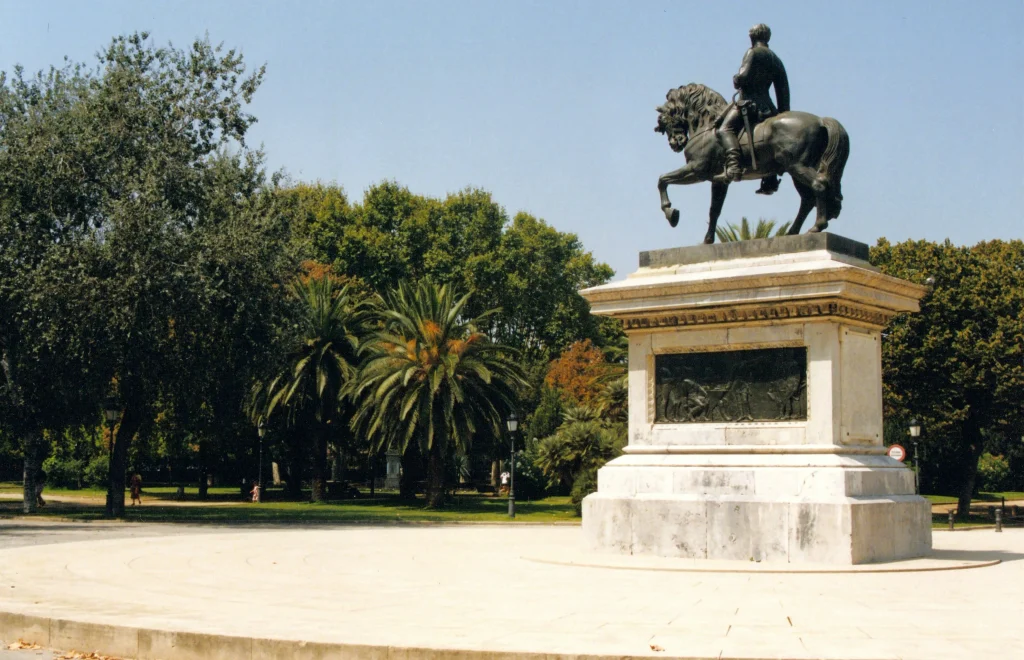 Equestrian monument surrounded by palm trees and greenery in Parc de la Ciutadella in Barcelona.