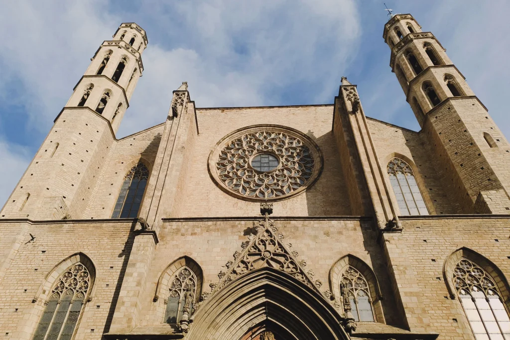 Façade of the Basilica of Santa Maria del Mar featuring its large Gothic rose window and twin towers in Barcelona.