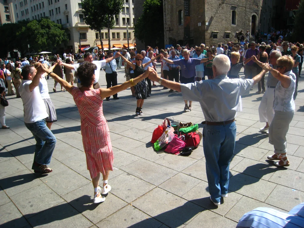 People dancing the traditional Catalan sardana in a circle in Barcelona.