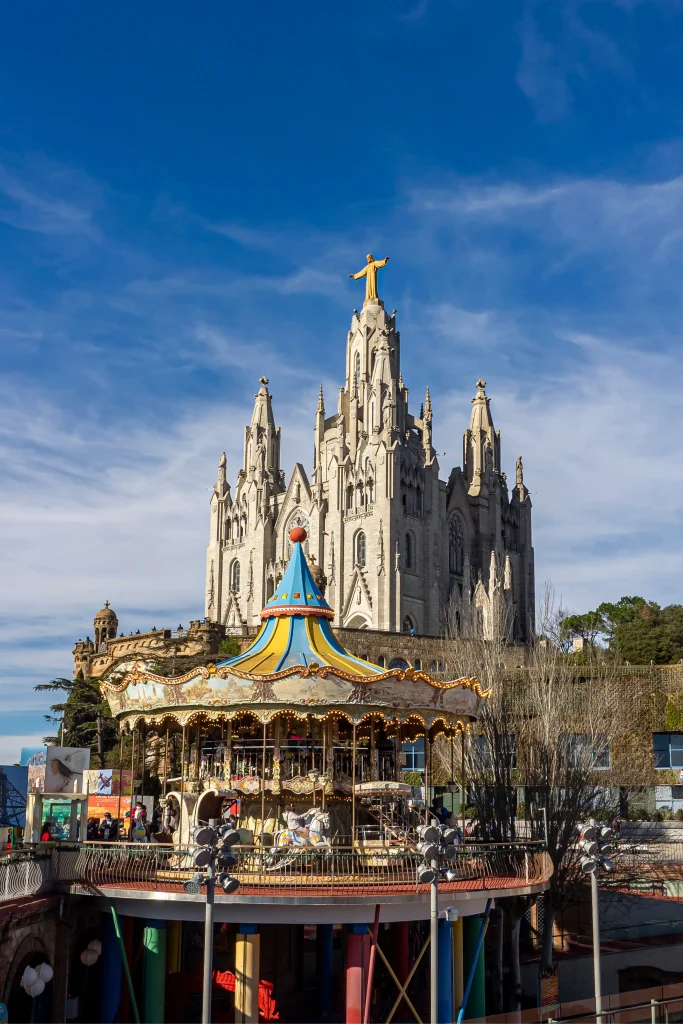 Temple of the Sacred Heart on Tibidabo overlooking the colourful amusement park in Barcelona.