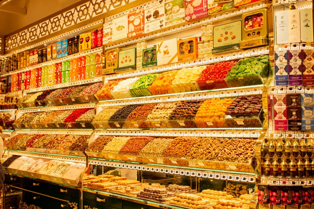 Colourful display of traditional sweets, dried fruits and nuts inside a specialty shop.